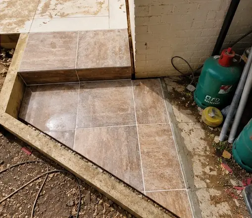 Porcelain step by the pool in West Byfleet, patios & porcelain paving by Beyond The Wall